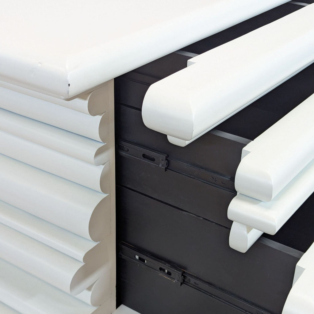 3. Close-up of Reperch dresser’s rounded white drawer fronts and black drawer interiors, highlighting details.