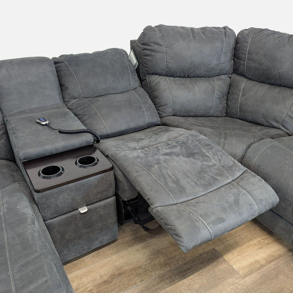 3. Close-up of La-Z-Boy sectional's power recline seat, center console with cupholders, and control remote visible.