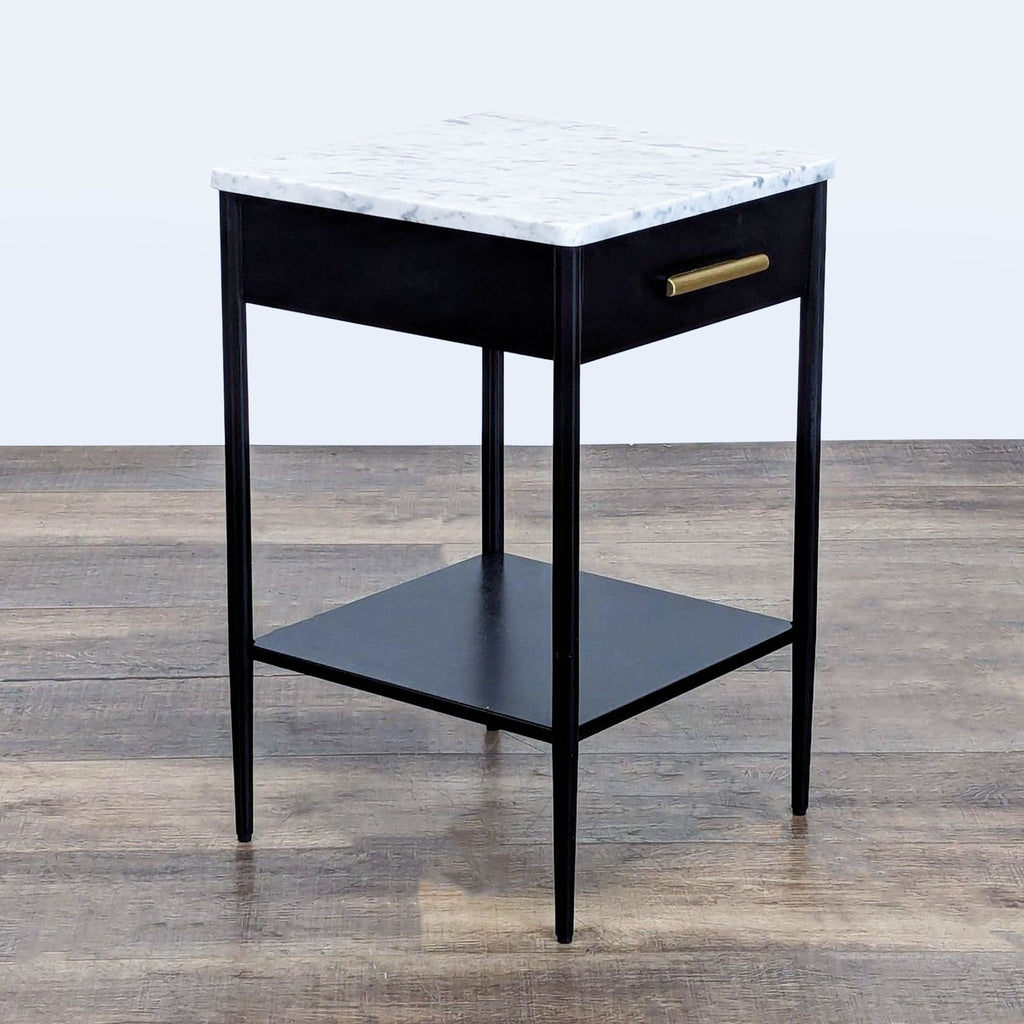 3. Modern black side table from West Elm featuring a marble top, storage drawer, and lower shelf.