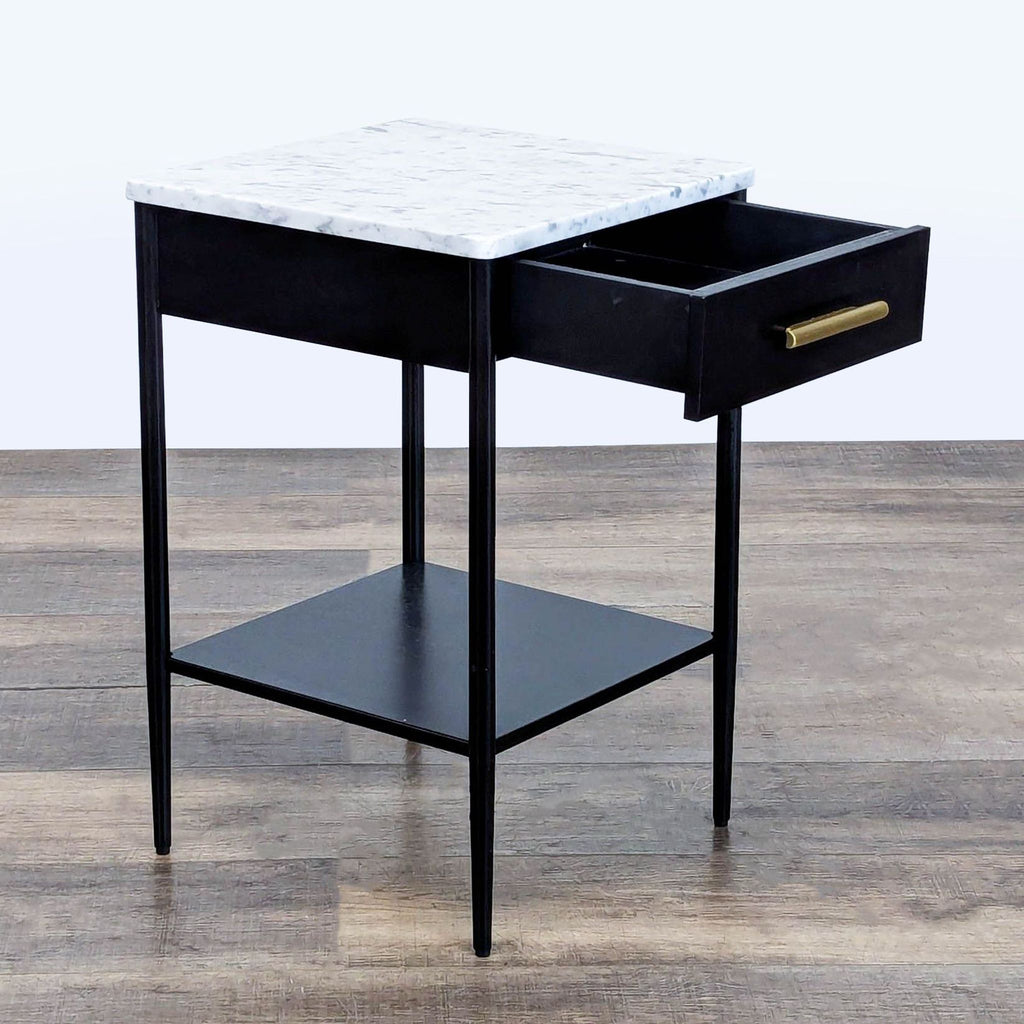 2. West Elm hot rolled steel table with marble top, open shelf, and drawer extended outward.