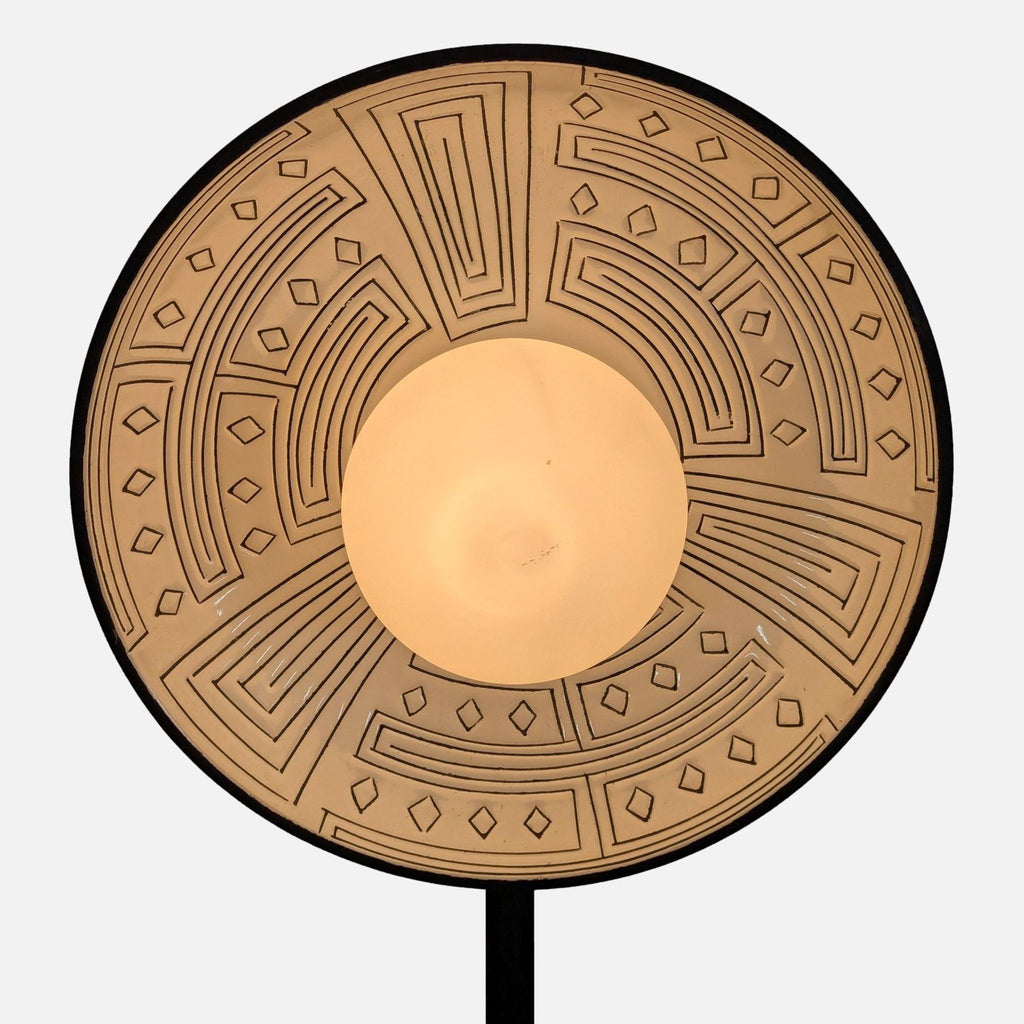 Close-up of ceramic lamp shade with intricate geometric designs, part of Anthropologie Lighting collection.