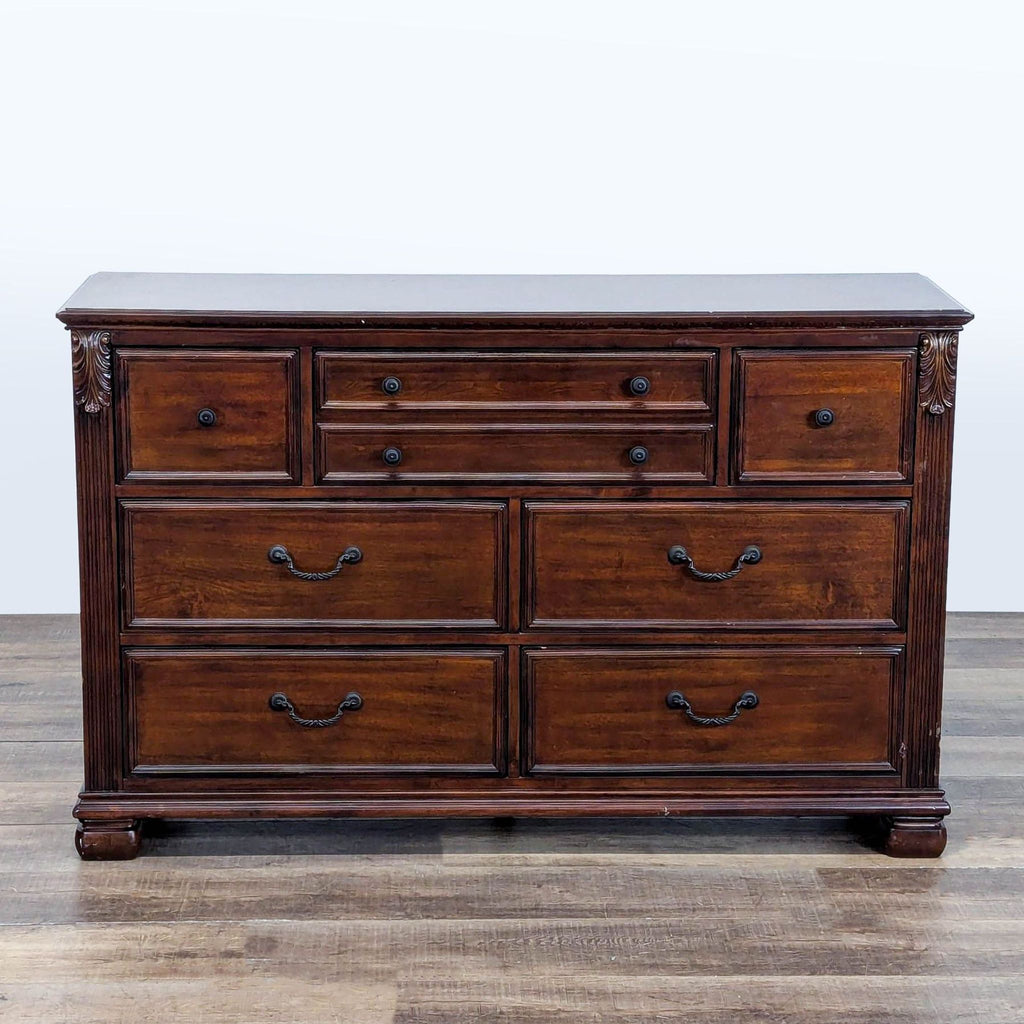 1. Ashley dresser with seven drawers, crafted from birch veneers, hardwood solids, and cast resin.  