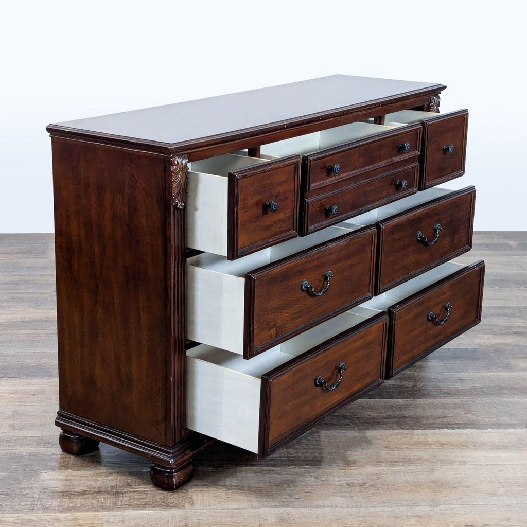 2. Side view of an Ashley dresser with drawers open, made of birch veneers and elegant detailing.  