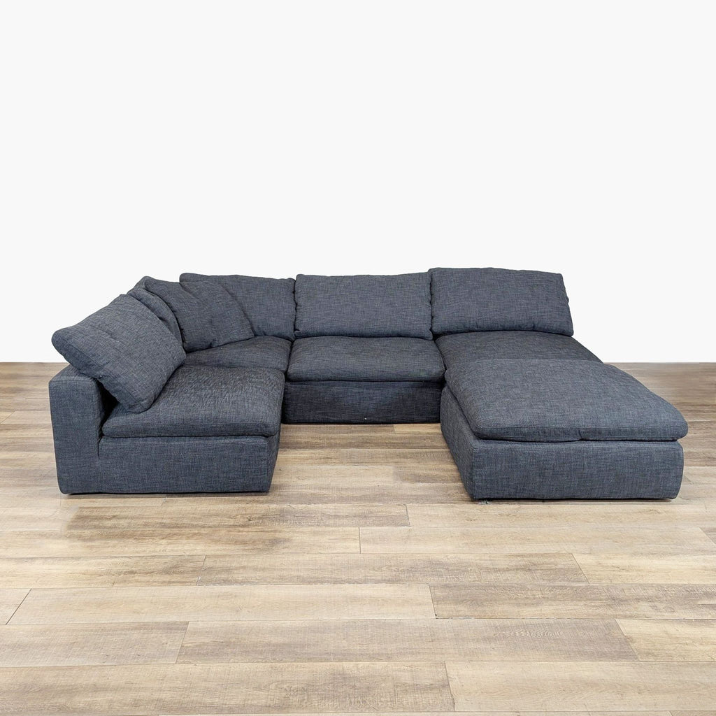 2. Large dark gray Restoration Hardware sectional sofa, deep seats and soft pillow backs, ideal for lounging. 