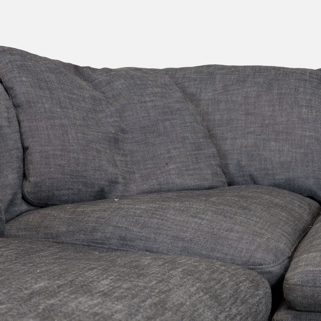 3. Close-up of the Cloud® sectional’s cozy, soft cushions, showing detailed gray fabric and inviting padding.