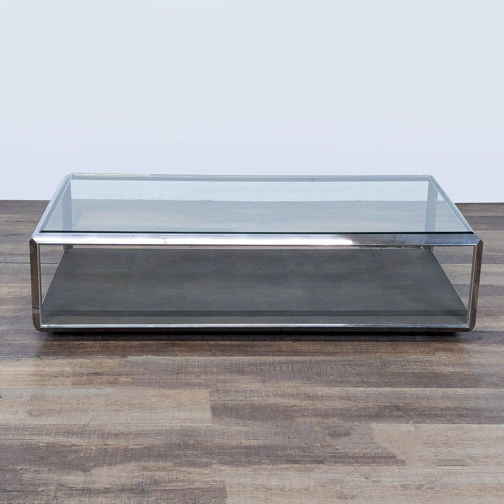 1. Rectangular Restoration Hardware coffee table with chrome frame, glass top, and metal textured shelf on wood floor.  