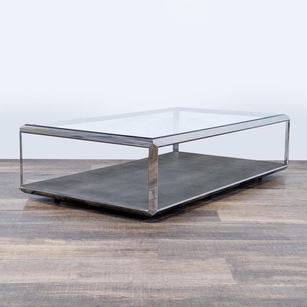 2. Angled view of modern coffee table by Restoration Hardware, chrome frame, glass surface, and textured metal lower shelf.  