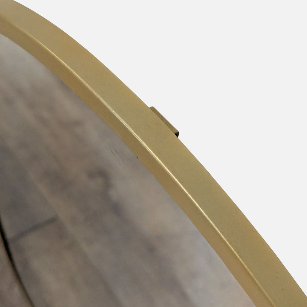 3. Detailed view of the arched Reperch mirror frame in gold, highlighting the top edge and mounting bracket.