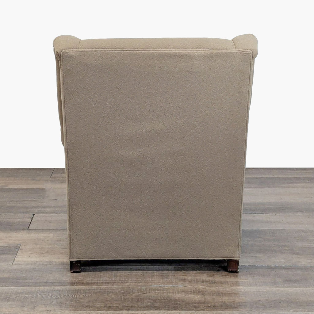 Back view of a taupe wool-upholstered lounge chair on wooden legs, Mitchell Gold + Bob Williams.