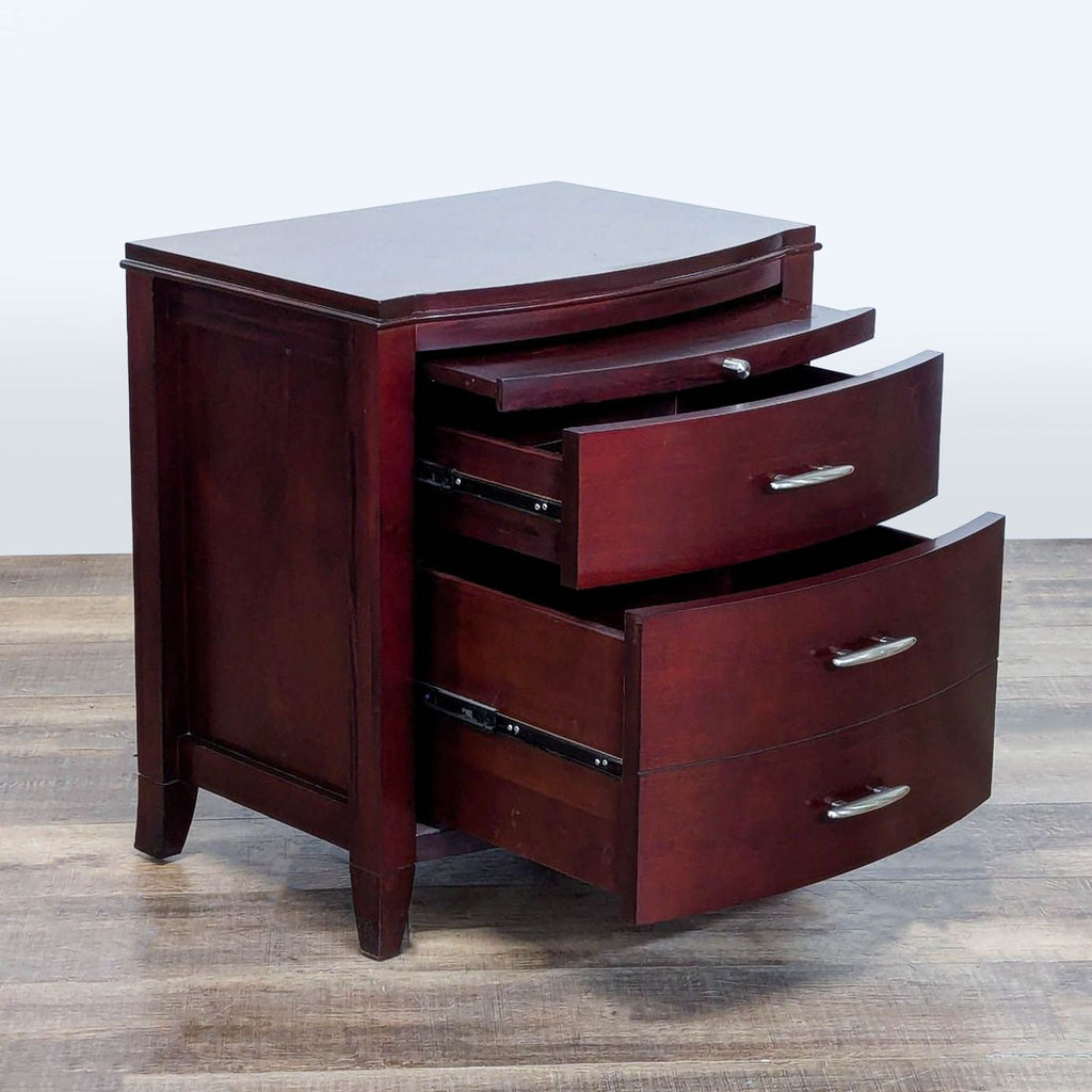 2. Cherry veneer end table by Modus Furniture, featuring three drawers and a pull-out tray partially extended.