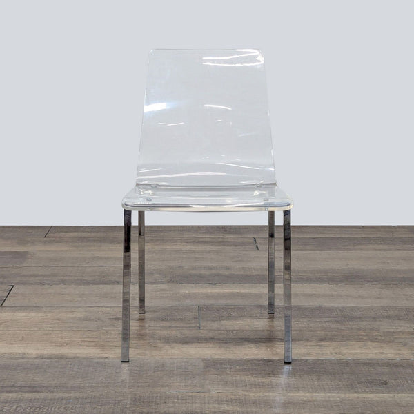 1. CB2 clear acrylic chair with slim nickel legs, shown from the front on a wooden floor.