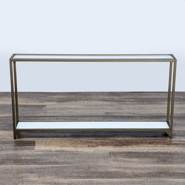 Slim Reperch console table with glass top and shelf, bronze metal frame, shown on wooden floor.