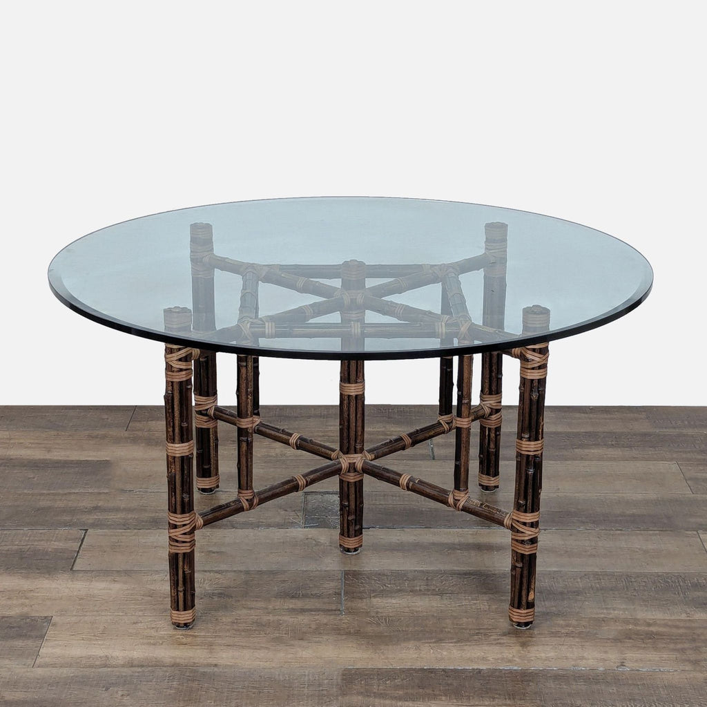 1. Round glass dining table by McGuire with bamboo base and patented leather strap lashing design.