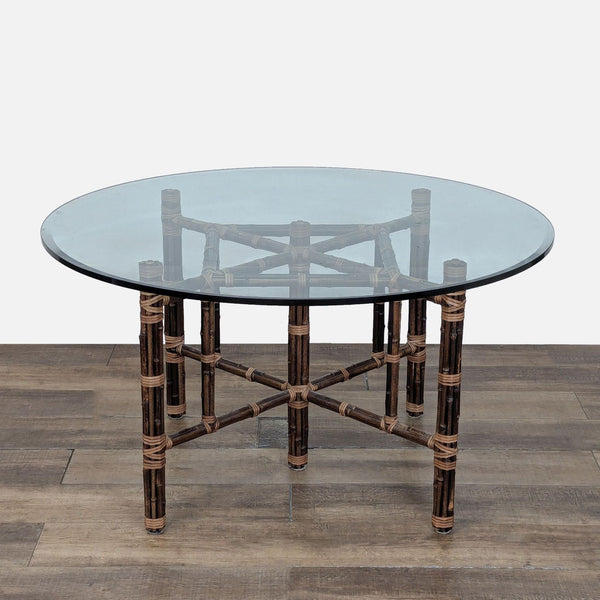 1. Round glass dining table by McGuire with bamboo base and patented leather strap lashing design.