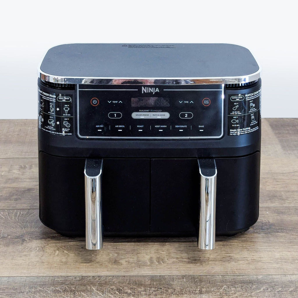 1. Black Ninja DualZone Air Fryer with two baskets and digital display, placed on a wooden surface.  