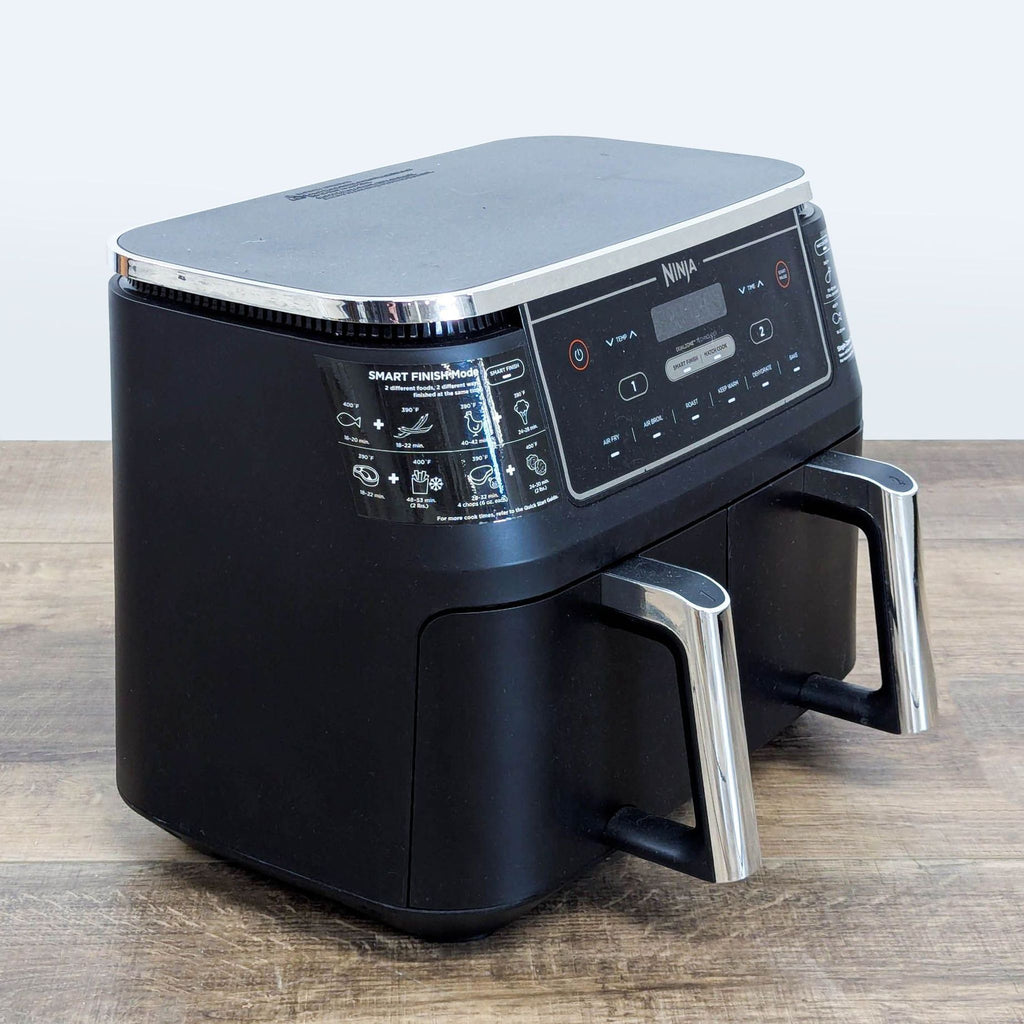3. Angled side view of the Ninja DualZone Air Fryer featuring chrome handles and labeled cooking modes.