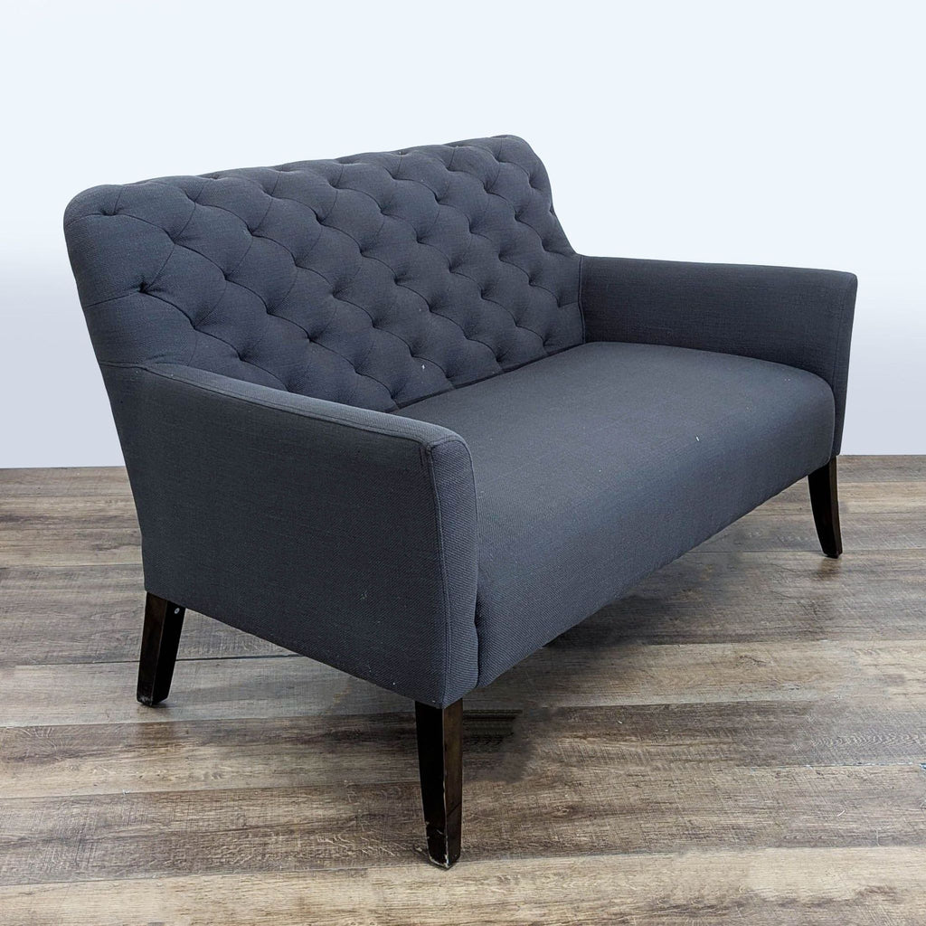 3. Angled view of Jason Furniture loveseat featuring tufted back, sleek fabric, and classic wood legs.