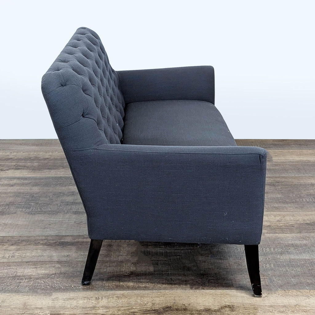 2. Side view of Jason Furniture loveseat, displaying tufted backrest, fabric upholstery, and wood legs.