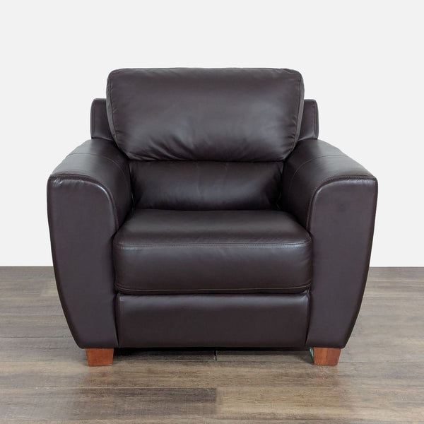 1. Front view of an Ikea lounge chair with dark leather upholstery and tapered wood block feet.