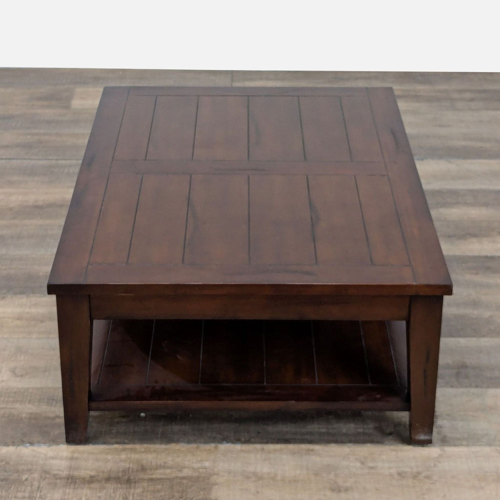 2. Top-down view of a World Market coffee table featuring a paneled surface and lower shelf, in dark wood.