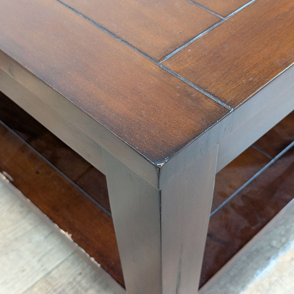3. Close-up of corner on a World Market coffee table, highlighting its rich wood grain and sturdy construction.