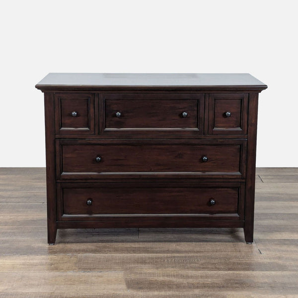 1. Pottery Barn dark wood dresser with 5 recessed panel drawers, shown against a light background.  