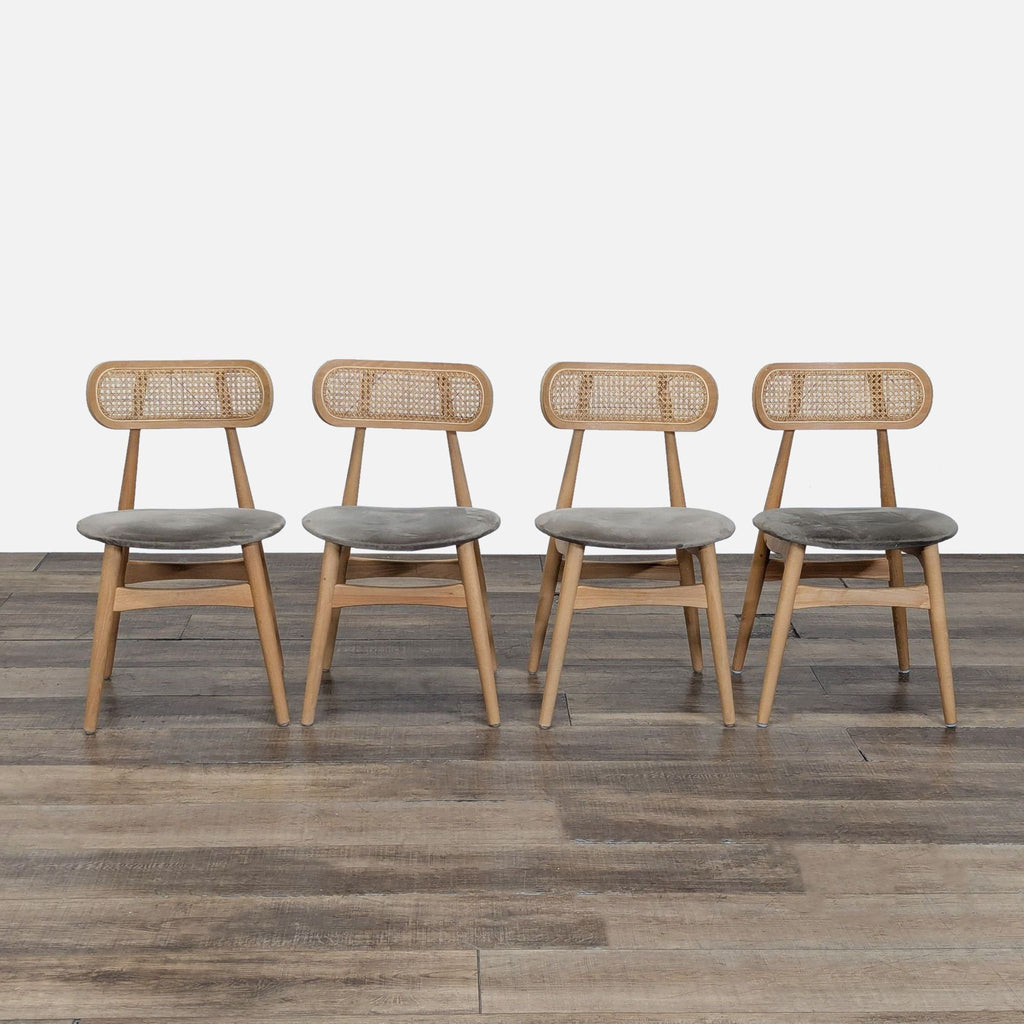 Set of four Reperch dining chairs with ash frames, cane backs, and upholstered seats arranged on wood floor.  