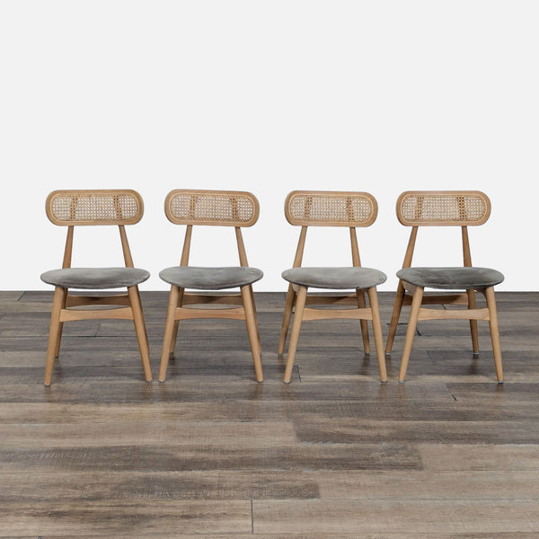 Set of four Reperch dining chairs with ash frames, cane backs, and upholstered seats arranged on wood floor.  