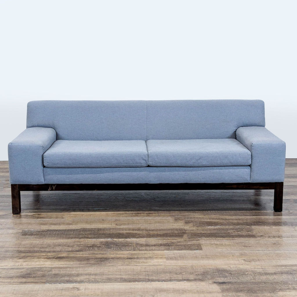 1. West Elm 3-seat sofa with wide track arms and wood legs, upholstered in a light blue fabric.