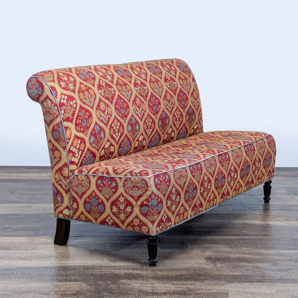 2. Patterned Reperch settee with ornate red and gold floral design, shown from an angled perspective.