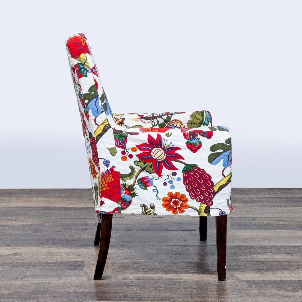 Side profile of a Reperch lounge chair featuring vibrant multicolored floral upholstery and straight wood legs.