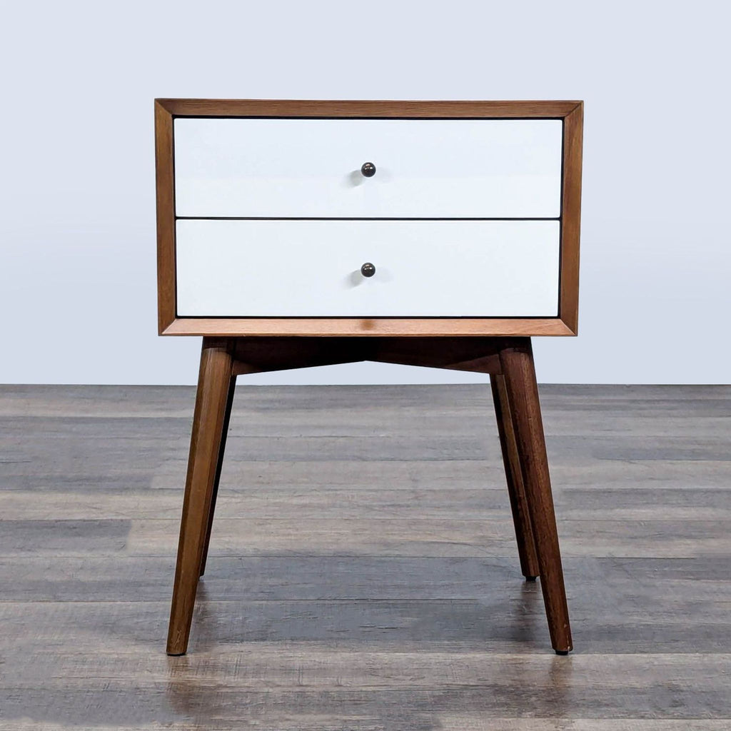 1. Mid-century modern West Elm end table with two white drawers, wooden frame, and angled legs.
