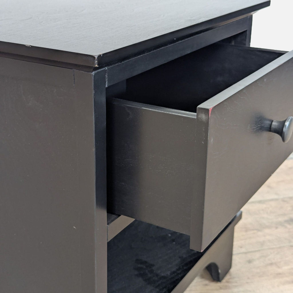3. Close-up of Pottery Barn side table drawer, highlighting the black finish and open shelf beneath.