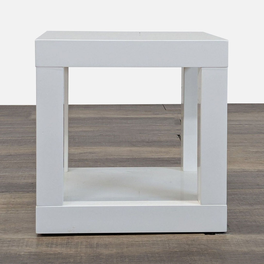 1. Modern white square side table by West Elm with an open base, shown on a wood floor.  