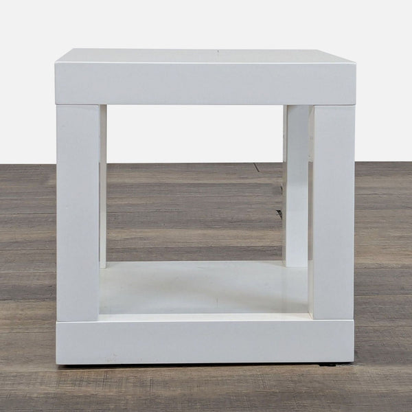 1. Modern white square side table by West Elm with an open base, shown on a wood floor.  