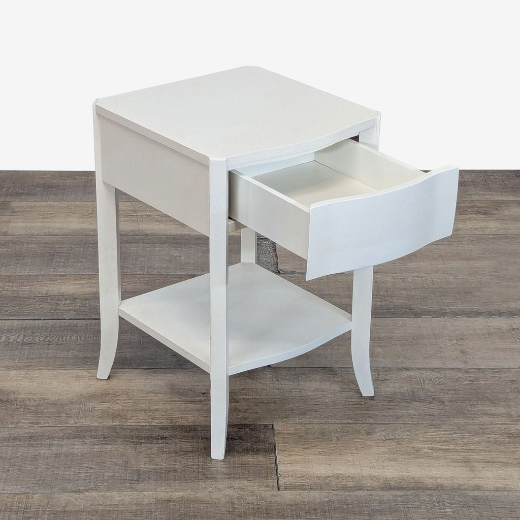 2. West Elm white side table with open drawer and lower shelf, angled to show interior storage.  