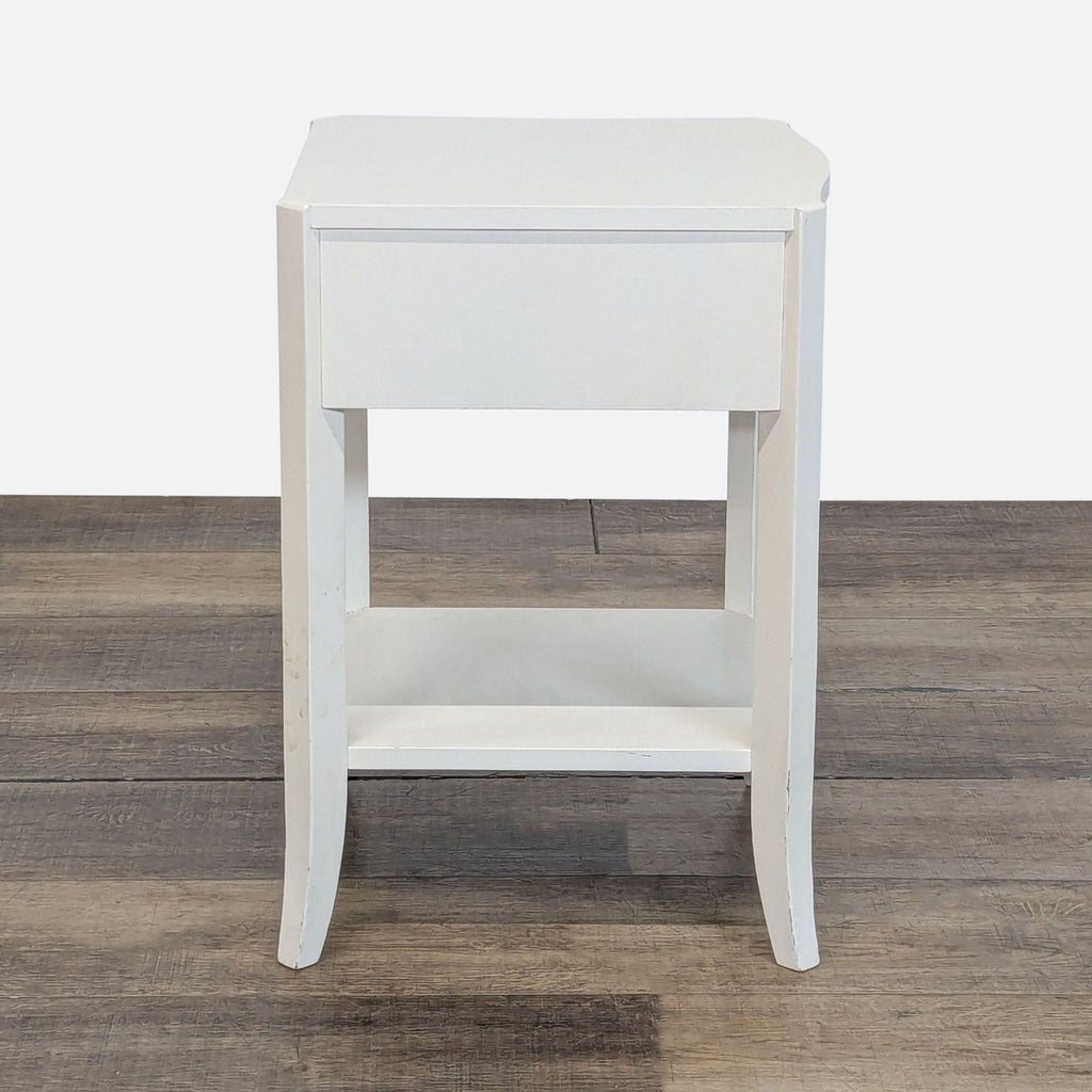 3. West Elm side table in white finish, featuring a single drawer and bottom shelf, rear view.