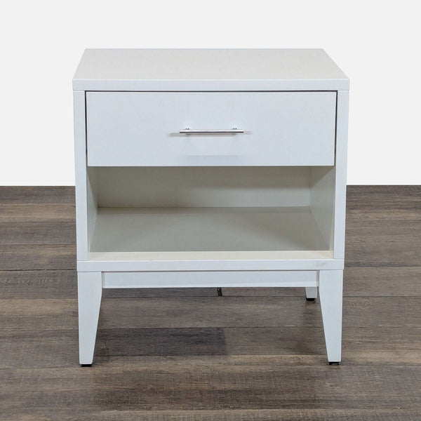 1. White West Elm end table with a single drawer and an open shelf, shown on a wooden floor.
