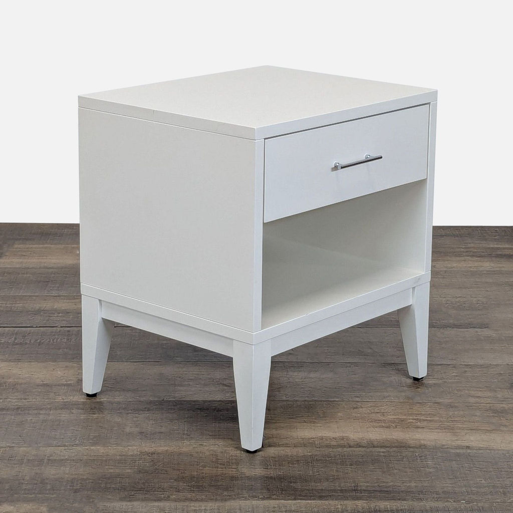 3. Modern white end table by West Elm, with one drawer and open shelf, angled from the side.