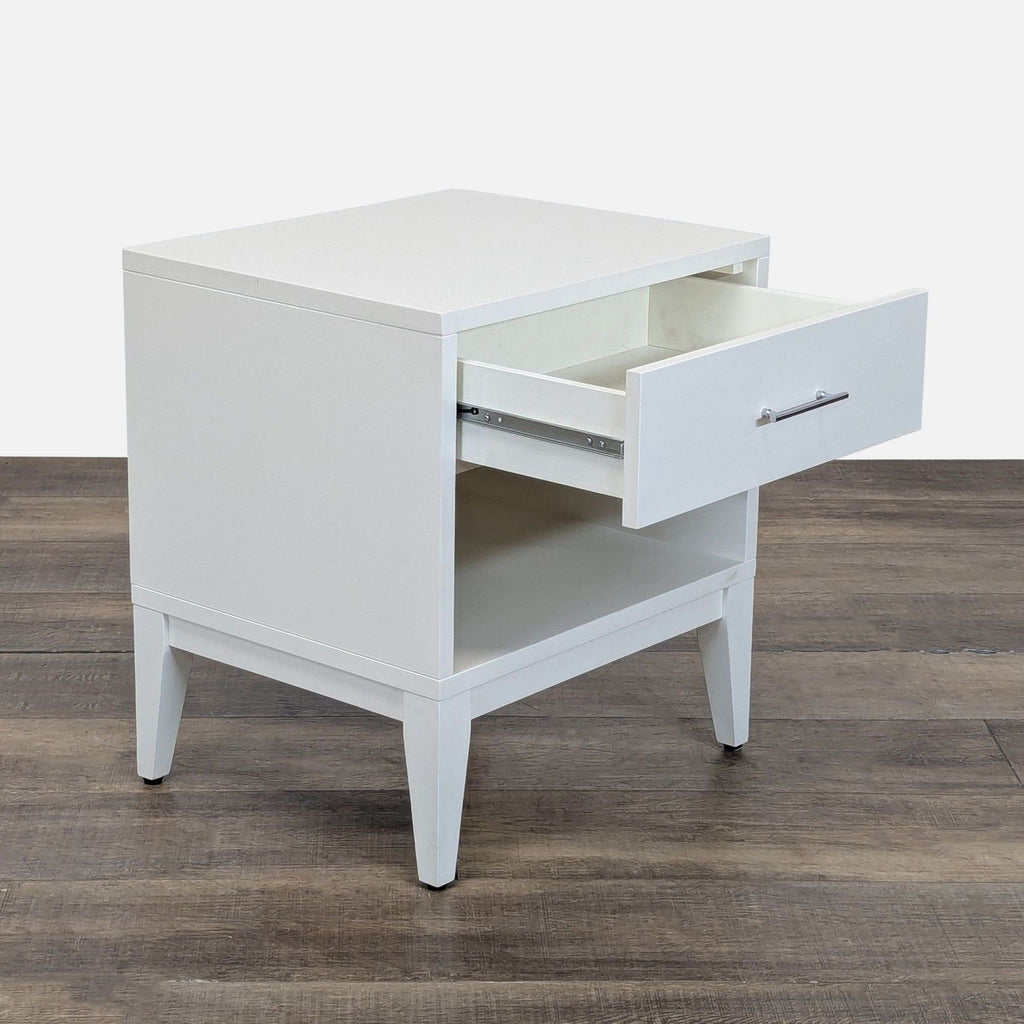 2. Angled view of a West Elm end table featuring one open drawer above an open shelf.