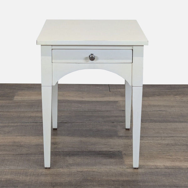 1. Reperch side table with a single drawer and tapered legs, shown on a wooden floor.  