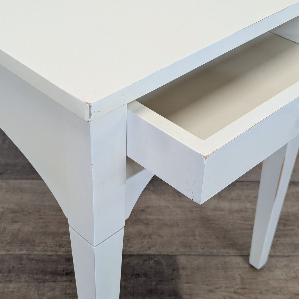 3. Close-up of the Reperch side table's open drawer and corner detailing, emphasizing finish and construction.