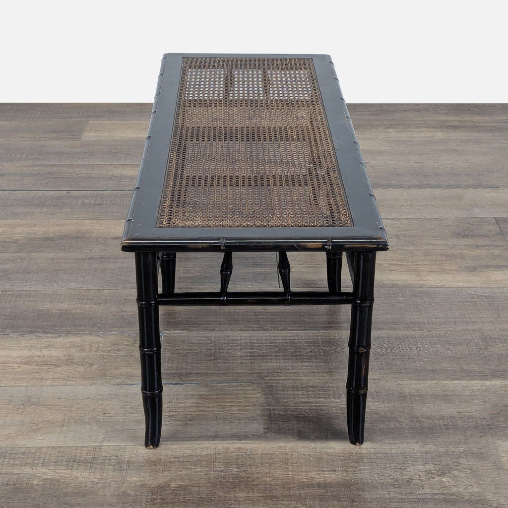 3. End view of a Reperch bench from the Stools, Ottomans & Benches category, black frame and rattan seat.