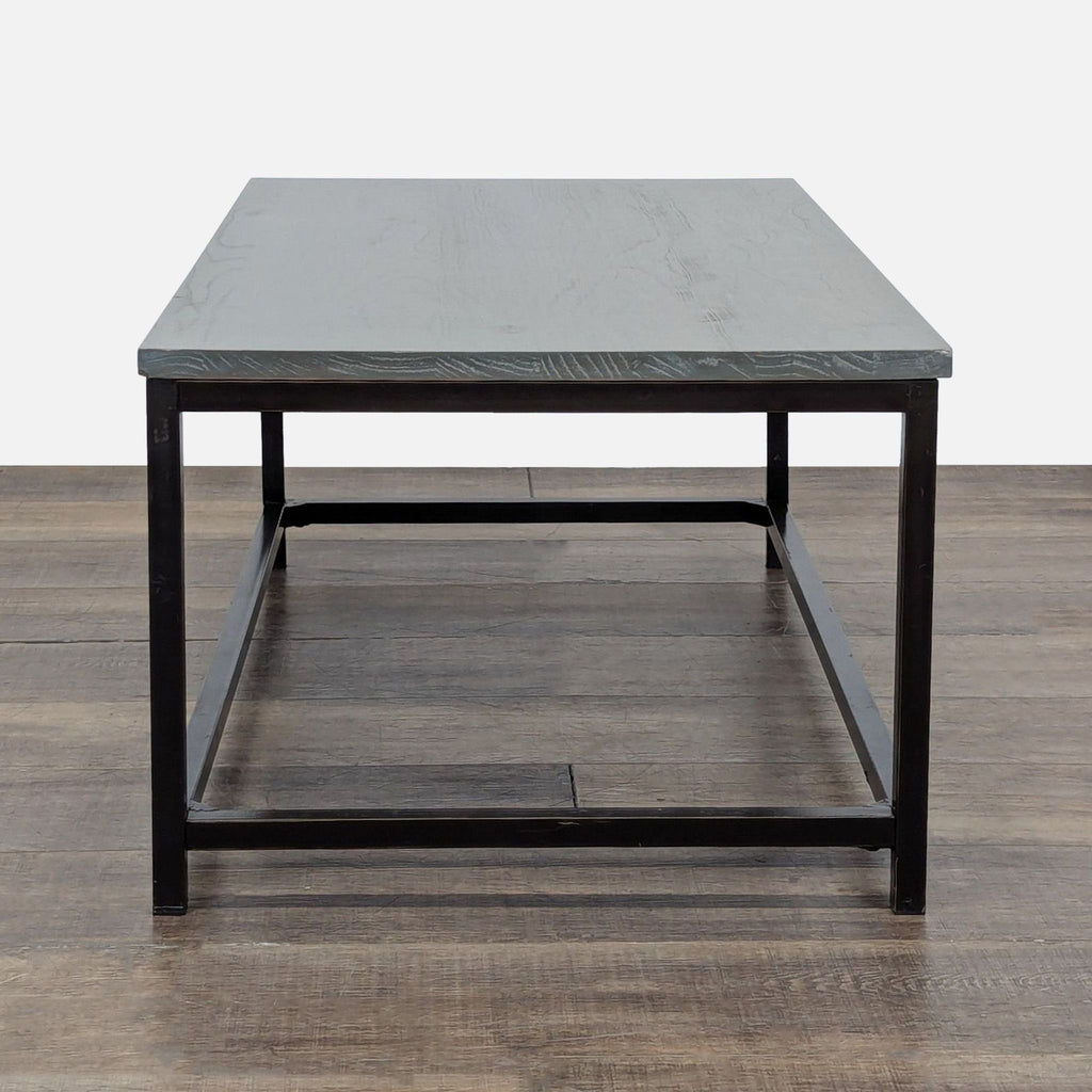 2. Side view of a Reperch coffee table, highlighting the sleek metal legs and gray wooden surface.