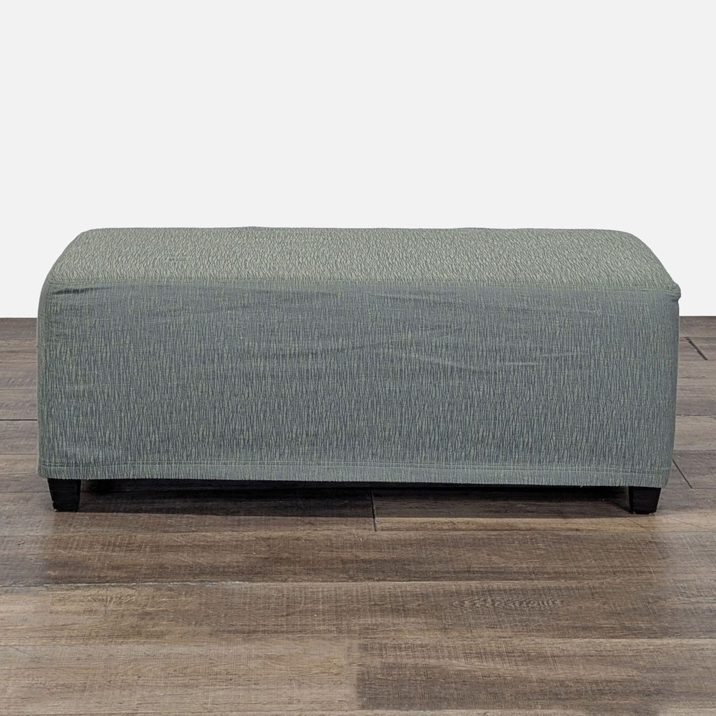 Slip Covered Ottoman on Wood Feet