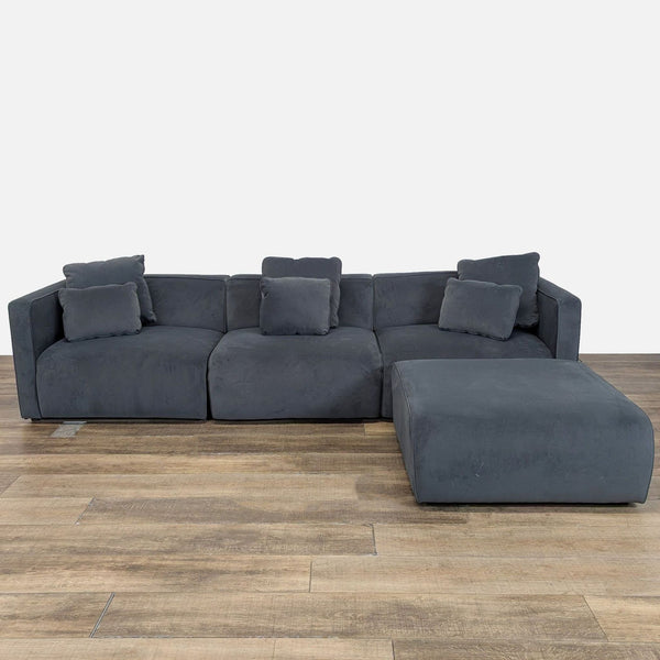 1. Living Spaces dark gray velvet sectional with removable cushions shown from the front on a wood floor.