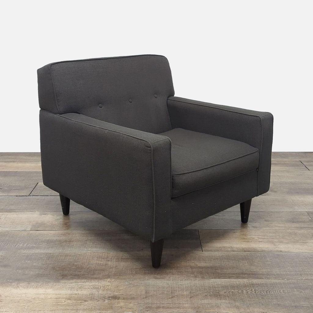 Side angle of a Max Home Furniture lounge chair featuring fabric upholstery, button tufting, and wooden legs.