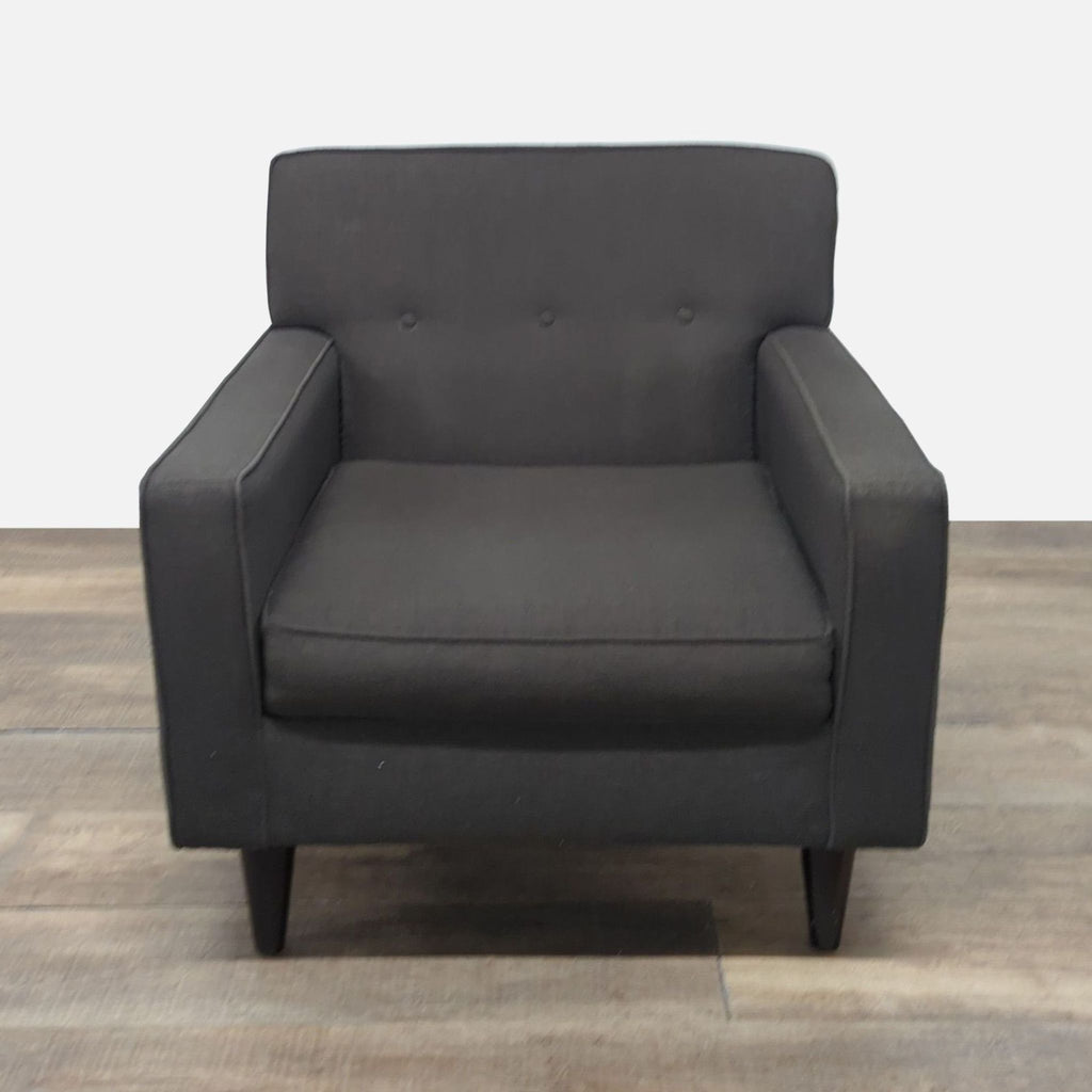 Dark fabric lounge chair by Max Home Furniture, with button tufting and tapered wood feet, front view.