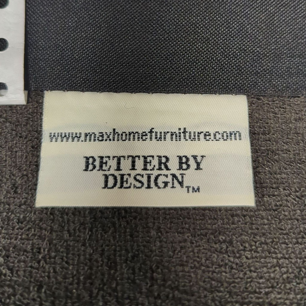 Close-up of Max Home Furniture label on lounge chair, displaying "Better by Design" branding.