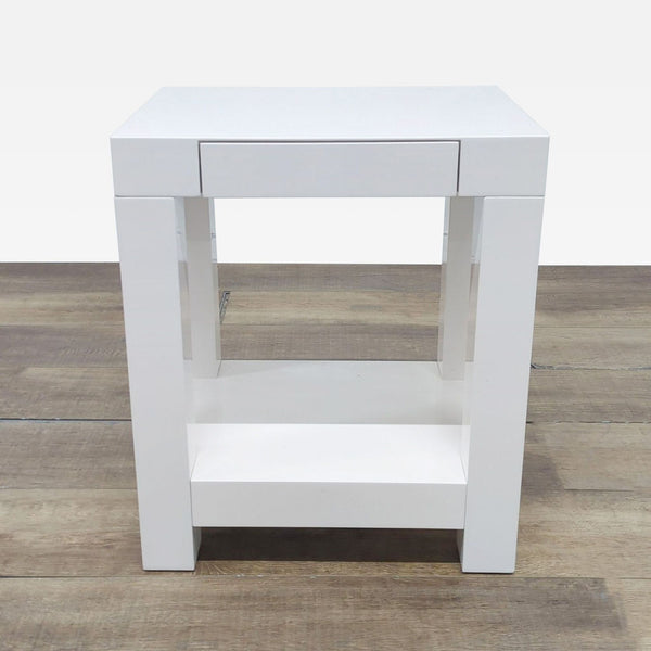 1. Modern white West Elm side table with a single drawer and a lower shelf, shown on wooden flooring.